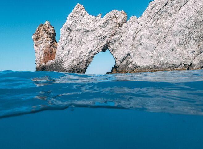 There is a portal-like rock (Tripia Petra) through which you can swim or kayak into another world