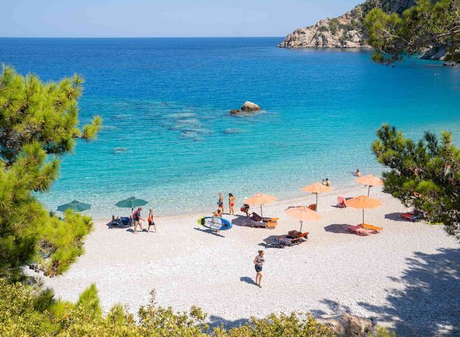 Apella is a setting of pine-tree green, white sand and deep blue sea