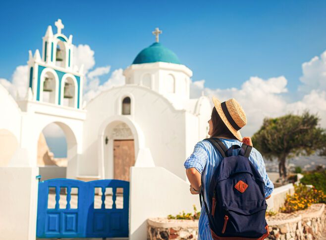 Santorini island traveler exploring greek church architecture in Akrotiri