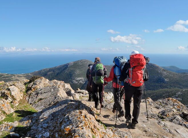 Hicking trail with people looking over the horizon
