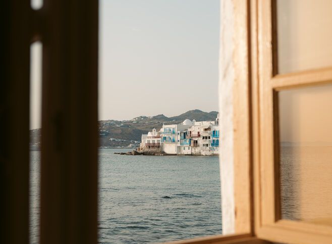 View of Mykonos through a balcony window