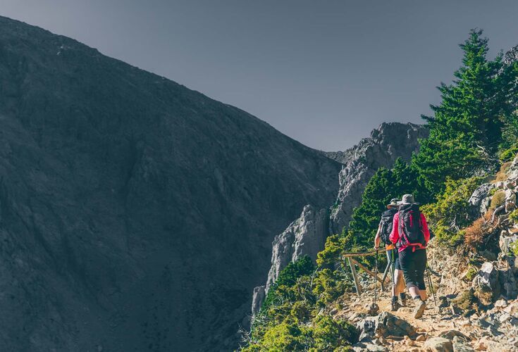 Along the way you will meet beautiful rock formations and cypress trees hanging on the edge of the path to Gigilos peak