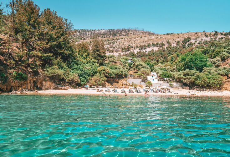 Pine trees and crysta clear waters on Arsanas beach in Thassos