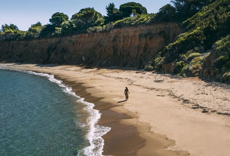 Mandraki beach, a shallow, sandy bay with blue-green water