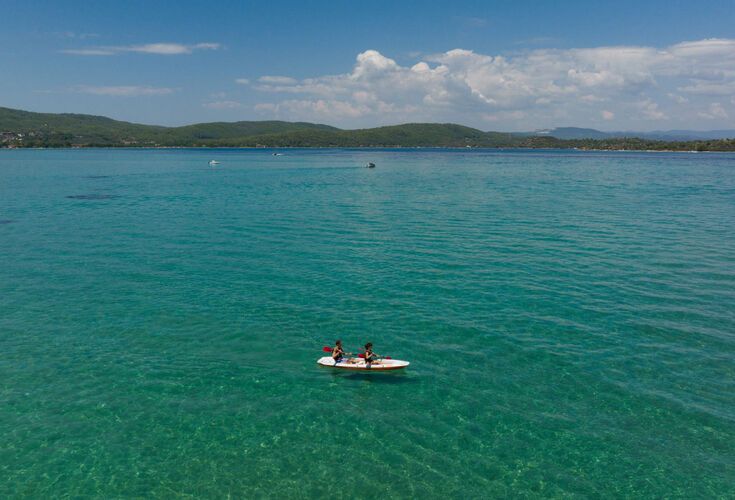 A boat with two people on the waters of Halkidiki