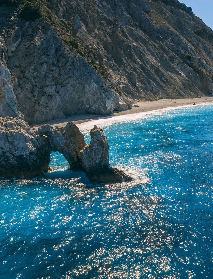 Lalaria, up on the north coast of Skiathos is unique for its smooth, pearly-white pebbles and dramatic cliff setting