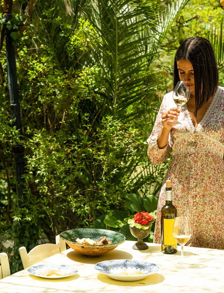 Woman tasting wine in a vineyard at Kefalonia