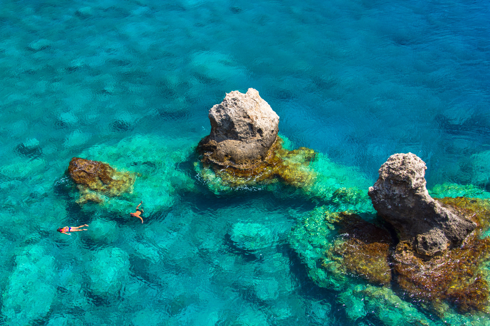 Above view of couple snorkeling in turquoise sea water, Glyka Nera, Chania
